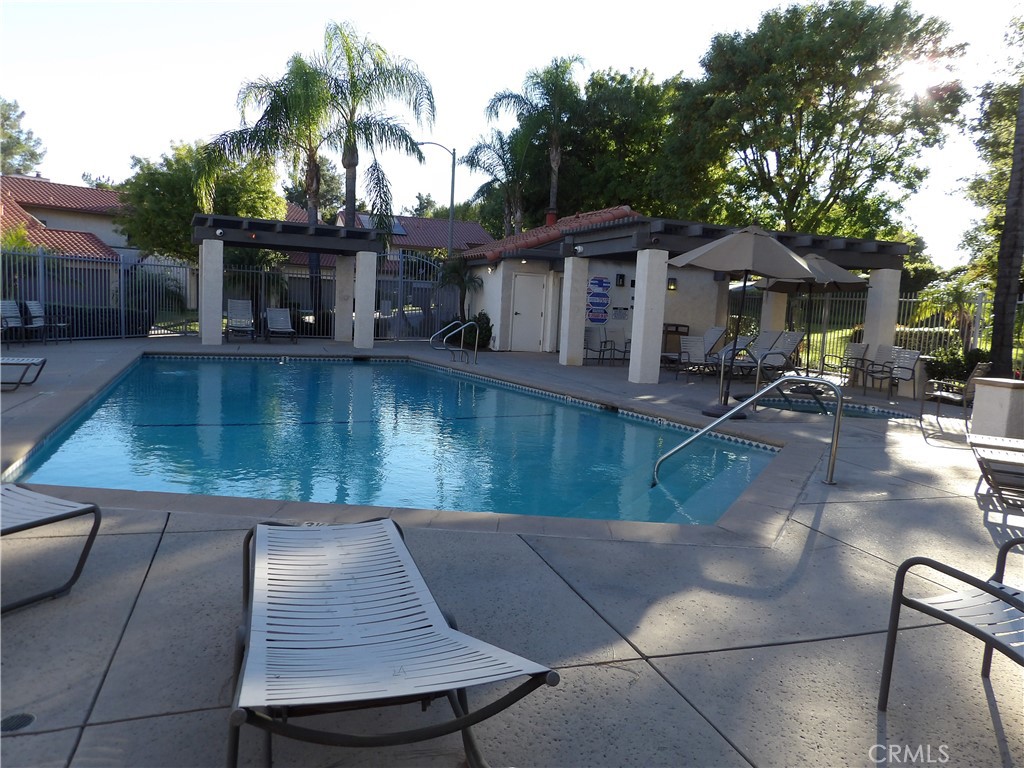 19140 Lahey Street, Unit 4 Porter Ranch, CA 91326 - Photo 34 of 37 a backyard of a house with table and chairs