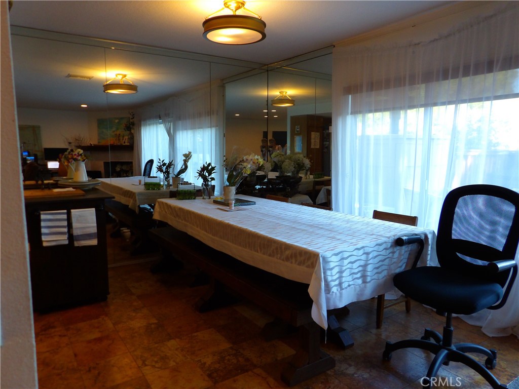 19140 Lahey Street, Unit 4 Porter Ranch, CA 91326 - Photo 5 of 37 a kitchen with sink dining table and chairs