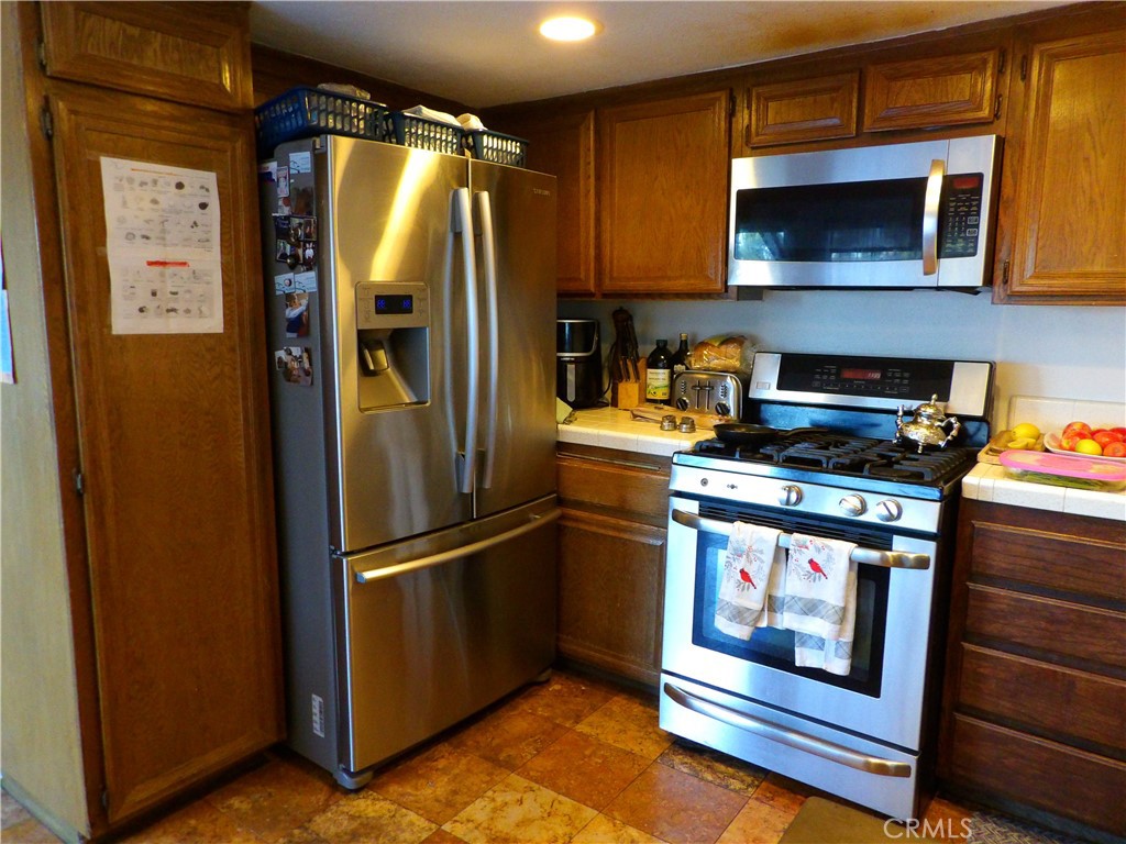 19140 Lahey Street, Unit 4 Porter Ranch, CA 91326 - Photo 7 of 37 a kitchen with a refrigerator stove and microwave