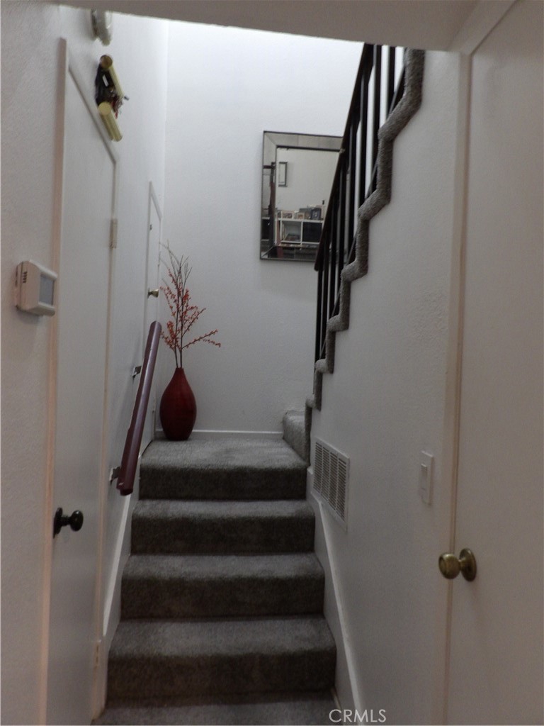 19140 Lahey Street, Unit 4 Porter Ranch, CA 91326 - Photo 8 of 37 a view of staircase with lots of frames on wall