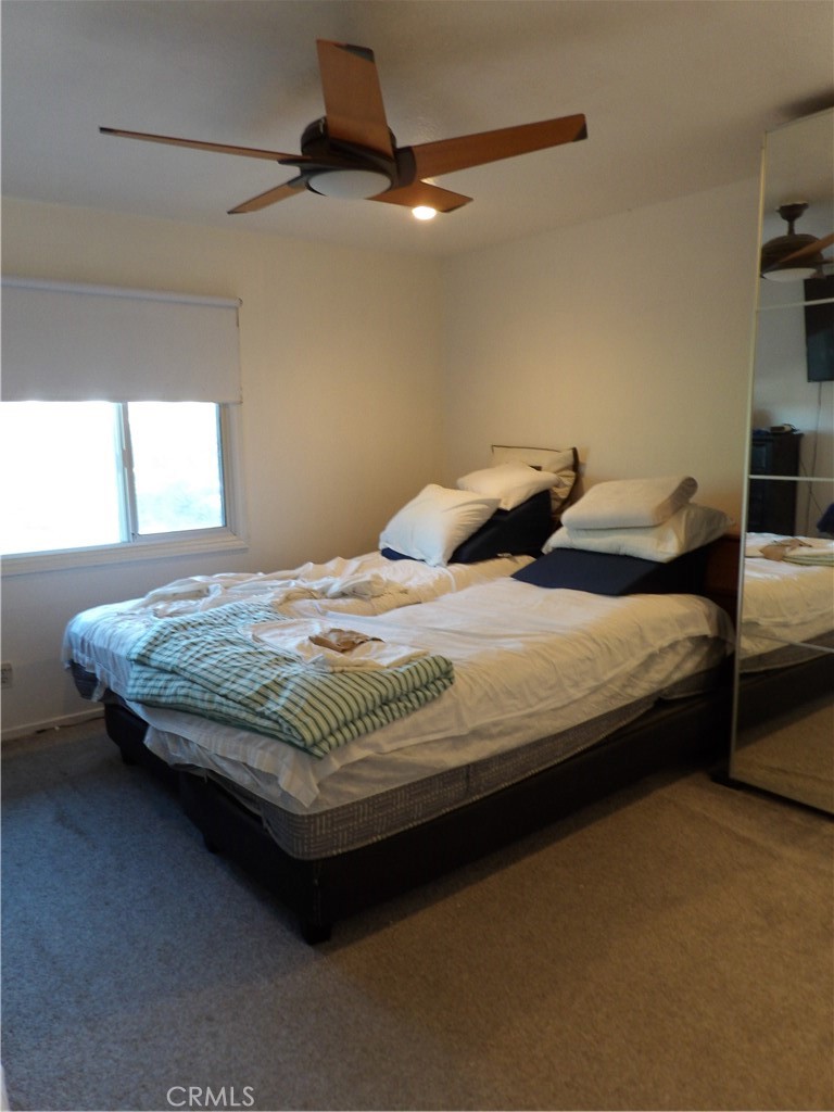 19140 Lahey Street, Unit 4 Porter Ranch, CA 91326 - Photo 10 of 37 a bedroom with a bed and a ceiling fan