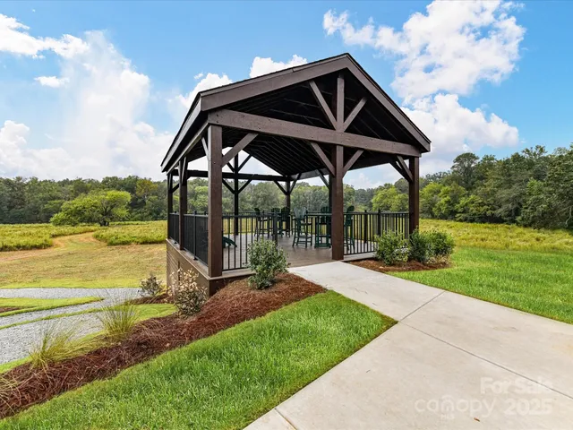 a view of chairs and table in the roof deck