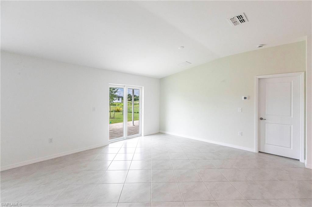 358 Pembroke Street Lehigh Acres, FL 33974 - Photo 13 of 45 a view of an empty room with a window