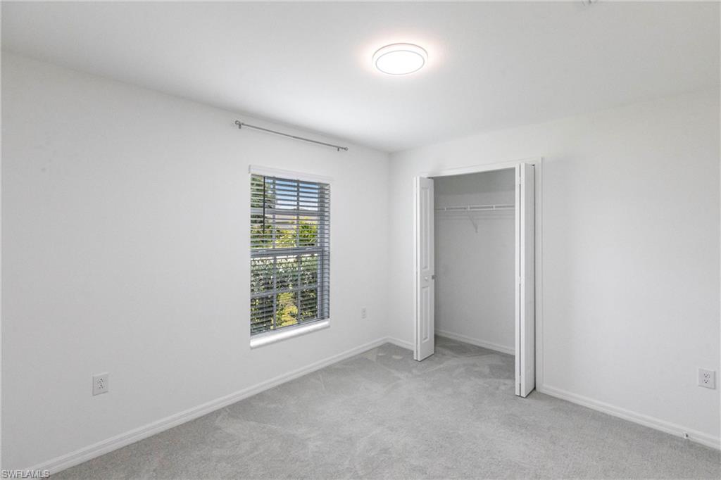358 Pembroke Street Lehigh Acres, FL 33974 - Photo 17 of 45 an empty room with windows