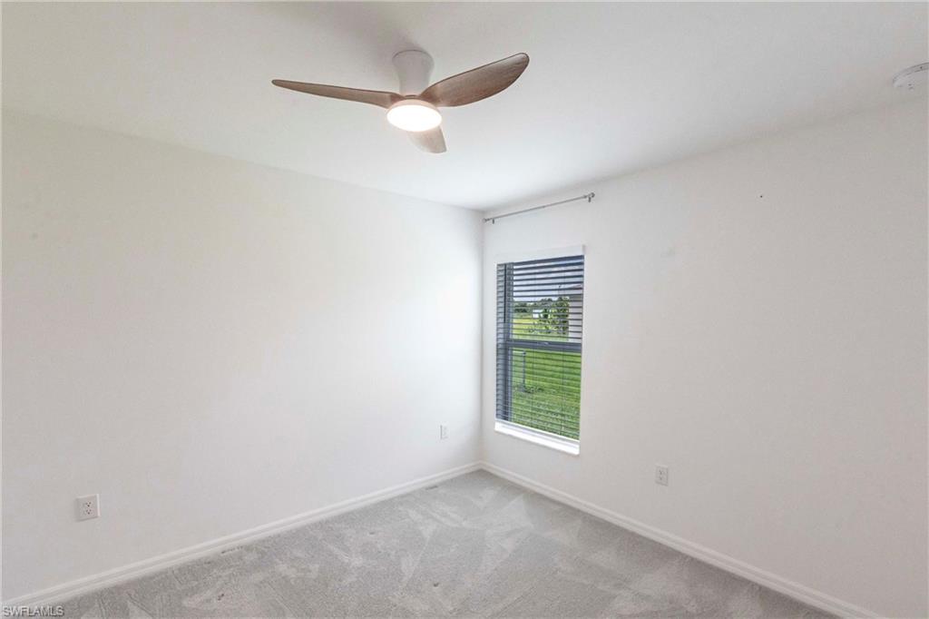 358 Pembroke Street Lehigh Acres, FL 33974 - Photo 20 of 45 an empty room with a fan and a window