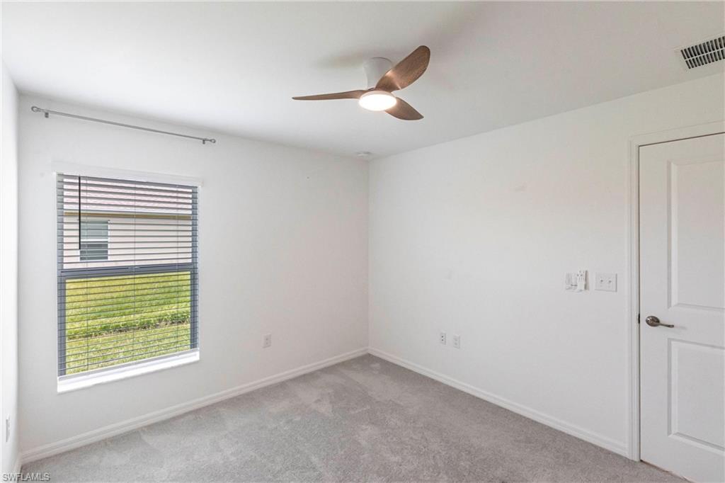 358 Pembroke Street Lehigh Acres, FL 33974 - Photo 23 of 45 a view of an empty room with a window