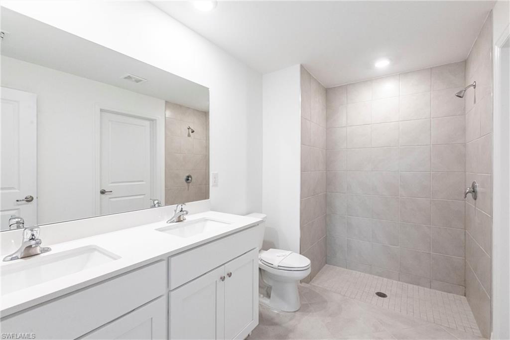 358 Pembroke Street Lehigh Acres, FL 33974 - Photo 26 of 45 a bathroom with a sink a toilet and shower
