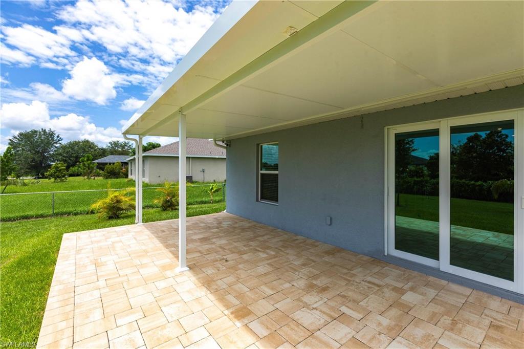 358 Pembroke Street Lehigh Acres, FL 33974 - Photo 35 of 45 a view of a house with backyard and porch