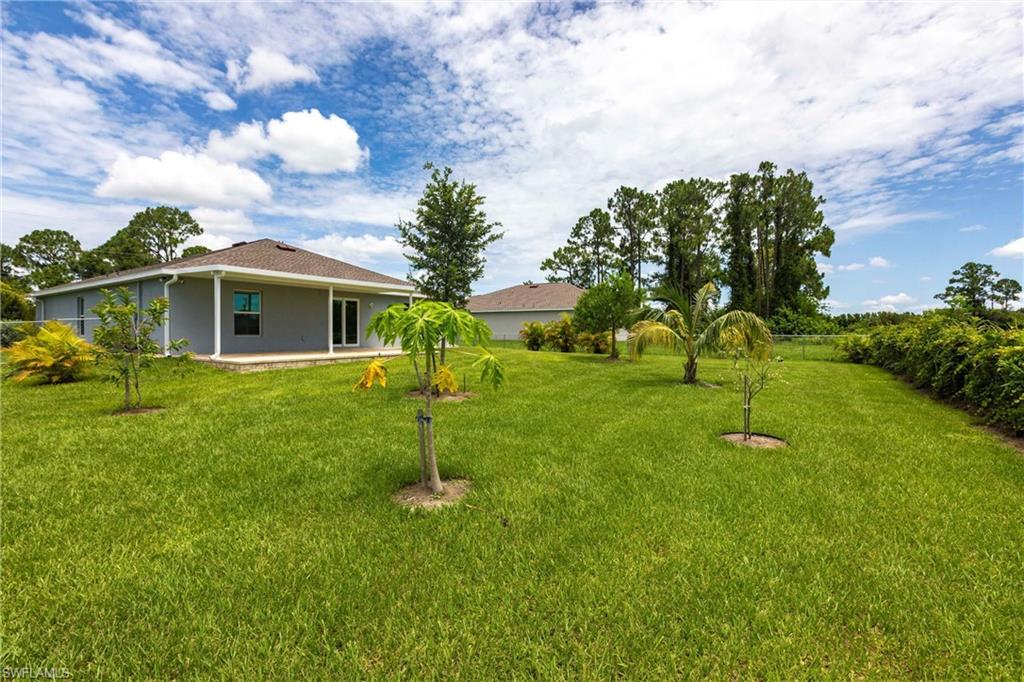 358 Pembroke Street Lehigh Acres, FL 33974 - Photo 36 of 45 a view of a house with a yard