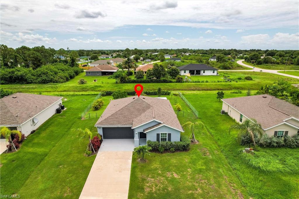 358 Pembroke Street Lehigh Acres, FL 33974 - Photo 40 of 45 an aerial view of a house with big yard