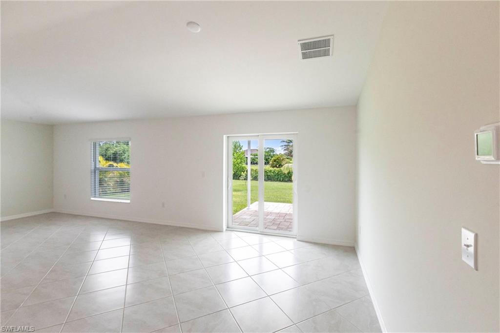 358 Pembroke Street Lehigh Acres, FL 33974 - Photo 4 of 45 a view of an empty room with a window