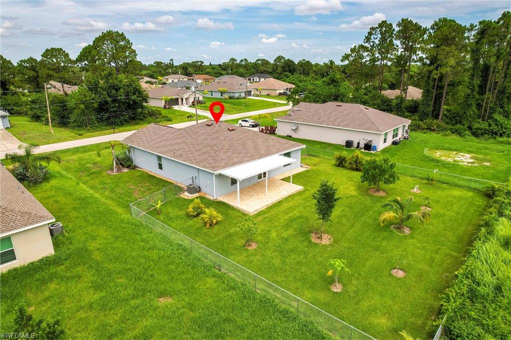 358 Pembroke Street Lehigh Acres, FL 33974 - Photo 43 of 45 an aerial view of a house with yard swimming pool and outdoor seating