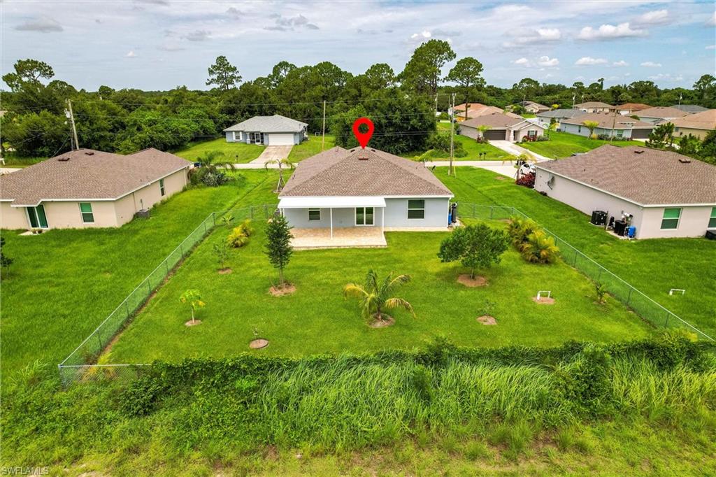 358 Pembroke Street Lehigh Acres, FL 33974 - Photo 44 of 45 a aerial view of residential houses with outdoor space and trees
