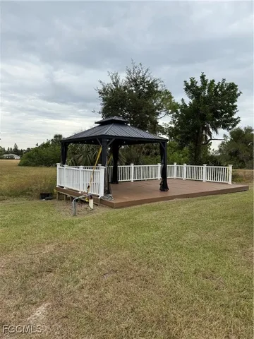 a view of a house with backyard and sitting area