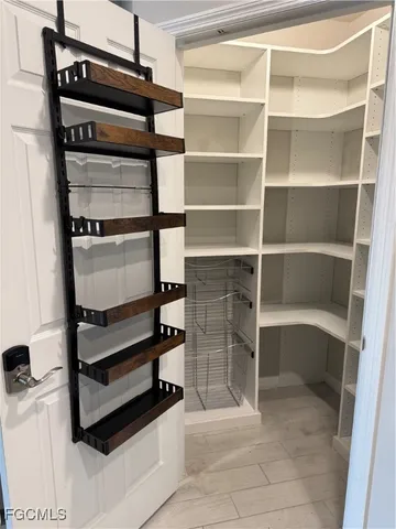 a view of walk in closet with empty racks