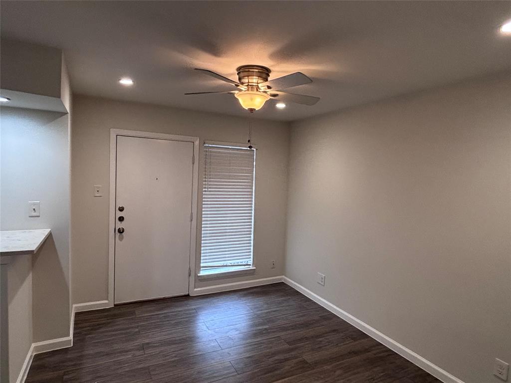 4300 Congress Avenue, Unit 216 Dallas, TX 75219 - Photo 1 of 13 an empty room with wooden floor chandelier fan and closet