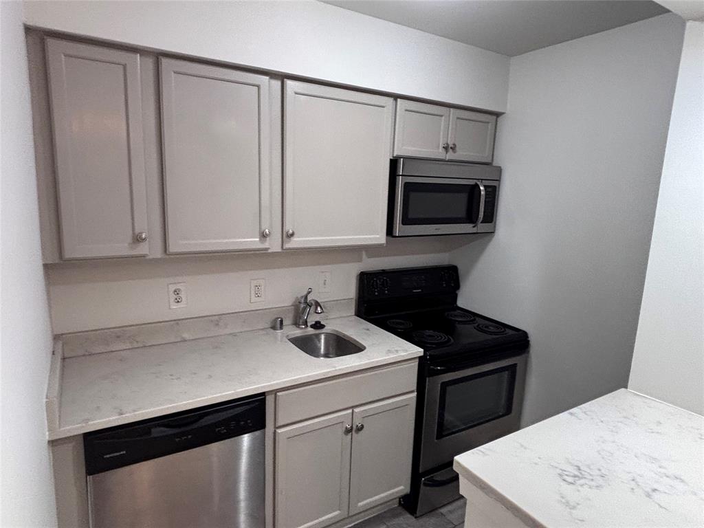 4300 Congress Avenue, Unit 216 Dallas, TX 75219 - Photo 4 of 13 a kitchen with a sink and cabinets