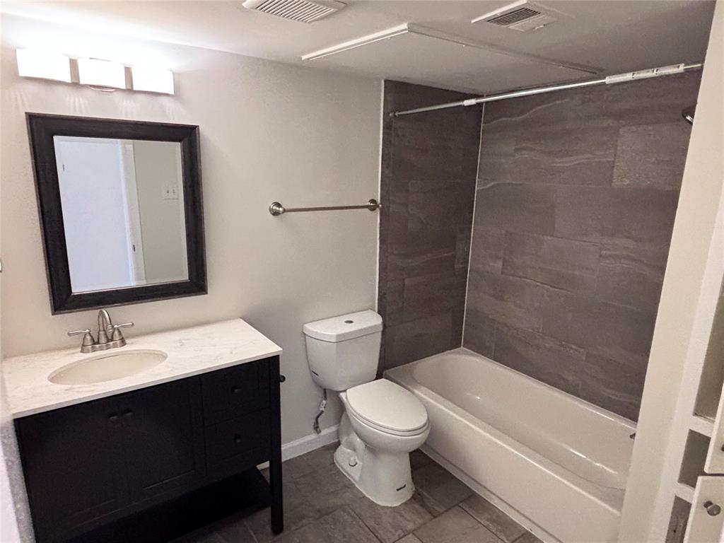 4300 Congress Avenue, Unit 216 Dallas, TX 75219 - Photo 6 of 13 a bathroom with a sink a toilet and shower