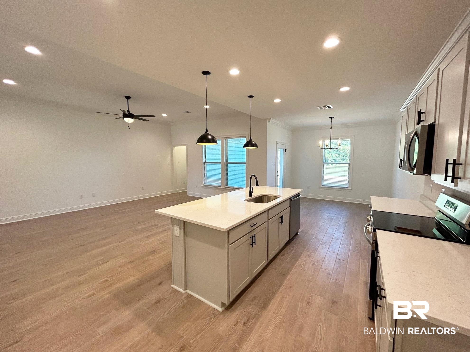 812 Sumter Loop Foley, AL 36535 - Photo 4 of 17 Kitchen with stainless steel appliances, sink, a center island with sink, light hardwood / wood-style floors, and hanging light fixtures