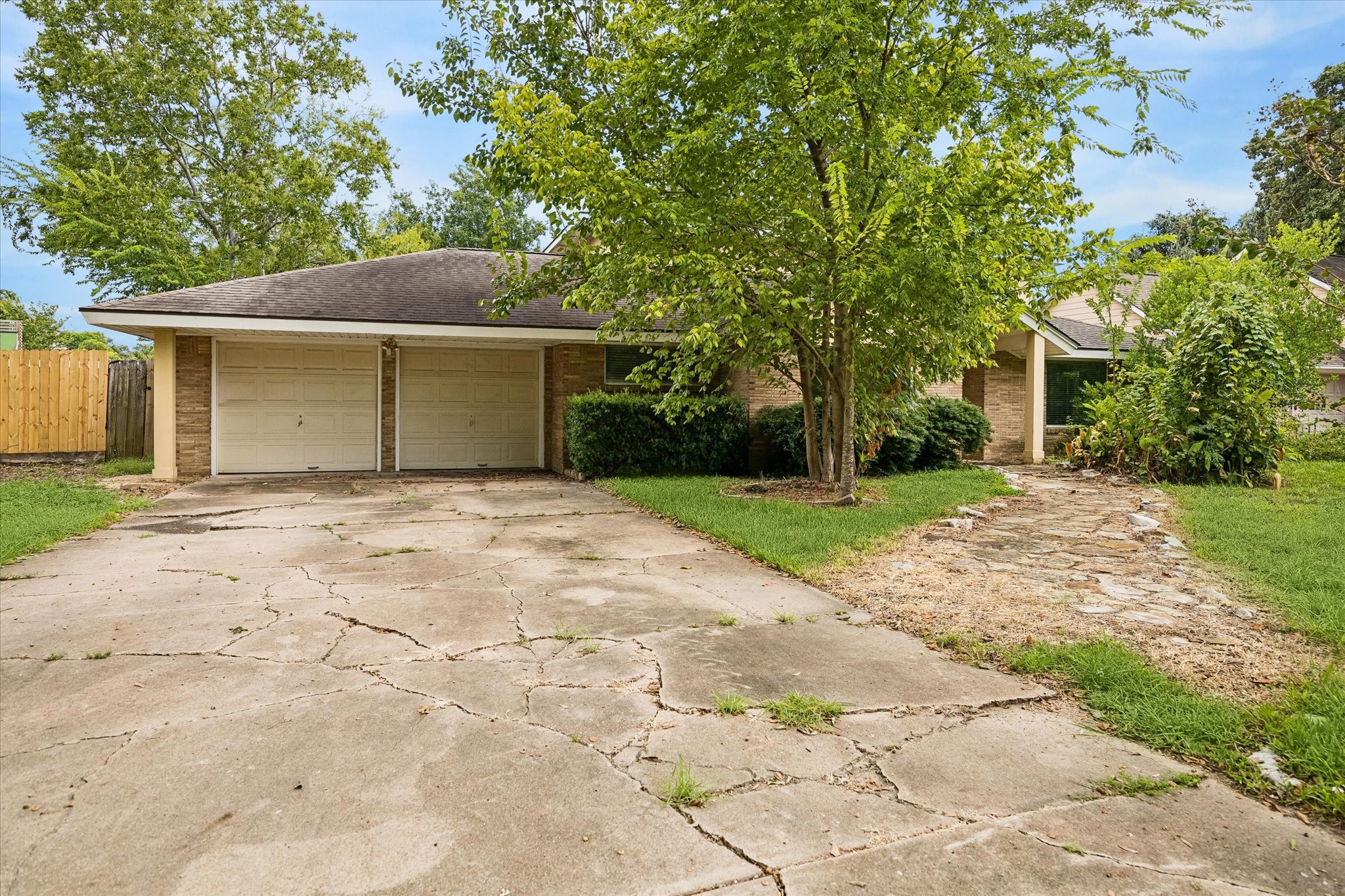 1740 Crownover Road Houston, TX 77080 - Photo 1 of 30 Front exterior of 1740 Crownover Road in Spring Branch Oaks with mature trees, driveway and attached garage