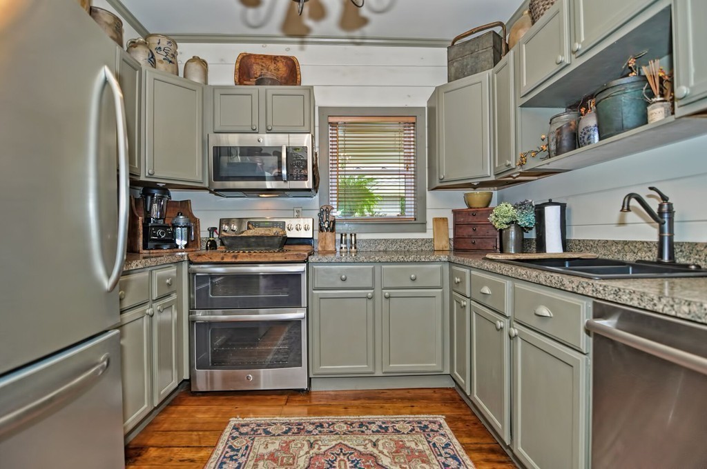 63 Wawela Park Road Webster, MA 01570 - Photo 15 of 30 a kitchen with stainless steel appliances granite countertop a refrigerator and a stove top oven