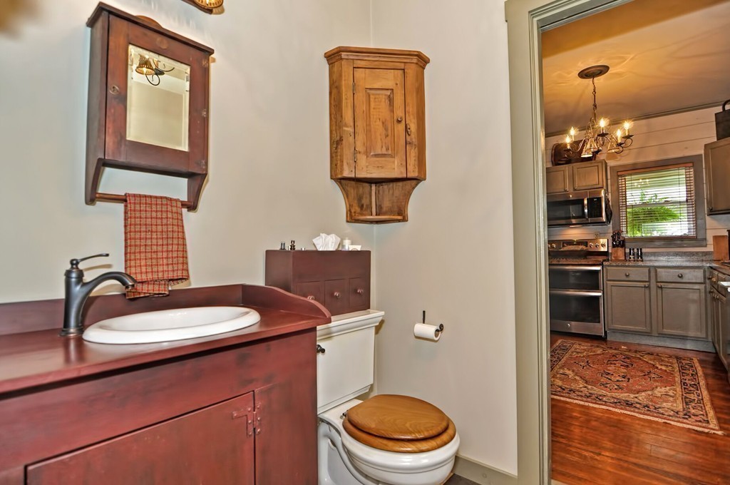 63 Wawela Park Road Webster, MA 01570 - Photo 22 of 30 a bathroom with a toilet a sink and mirror