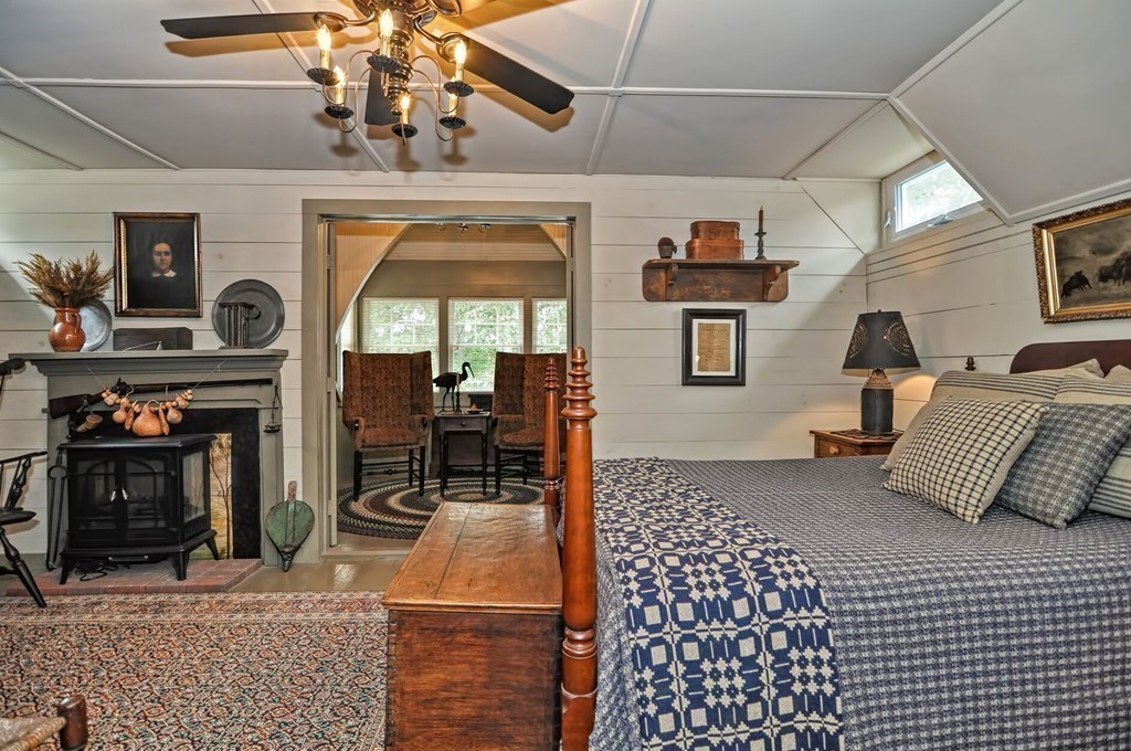 63 Wawela Park Road Webster, MA 01570 - Photo 23 of 30 a bedroom with furniture and a fireplace