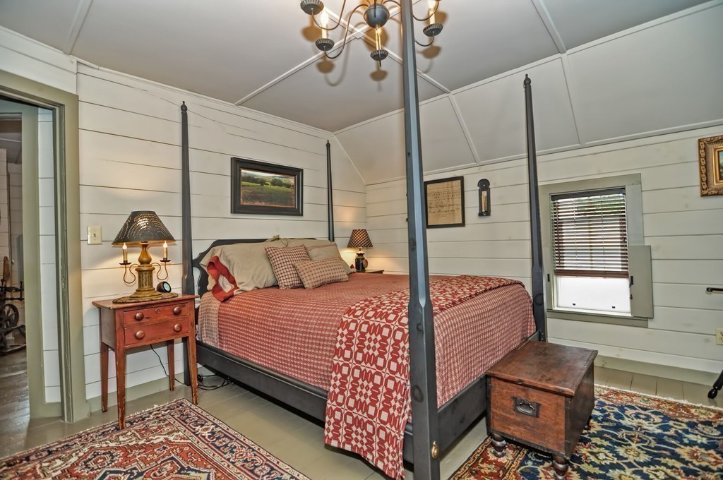 63 Wawela Park Road Webster, MA 01570 - Photo 26 of 30 a bedroom with a bed and wooden floor