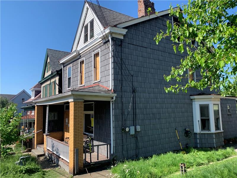 134 Rinne Street Pittsburgh, PA 15210 - Photo 22 of 23 front view of a house with a small yard