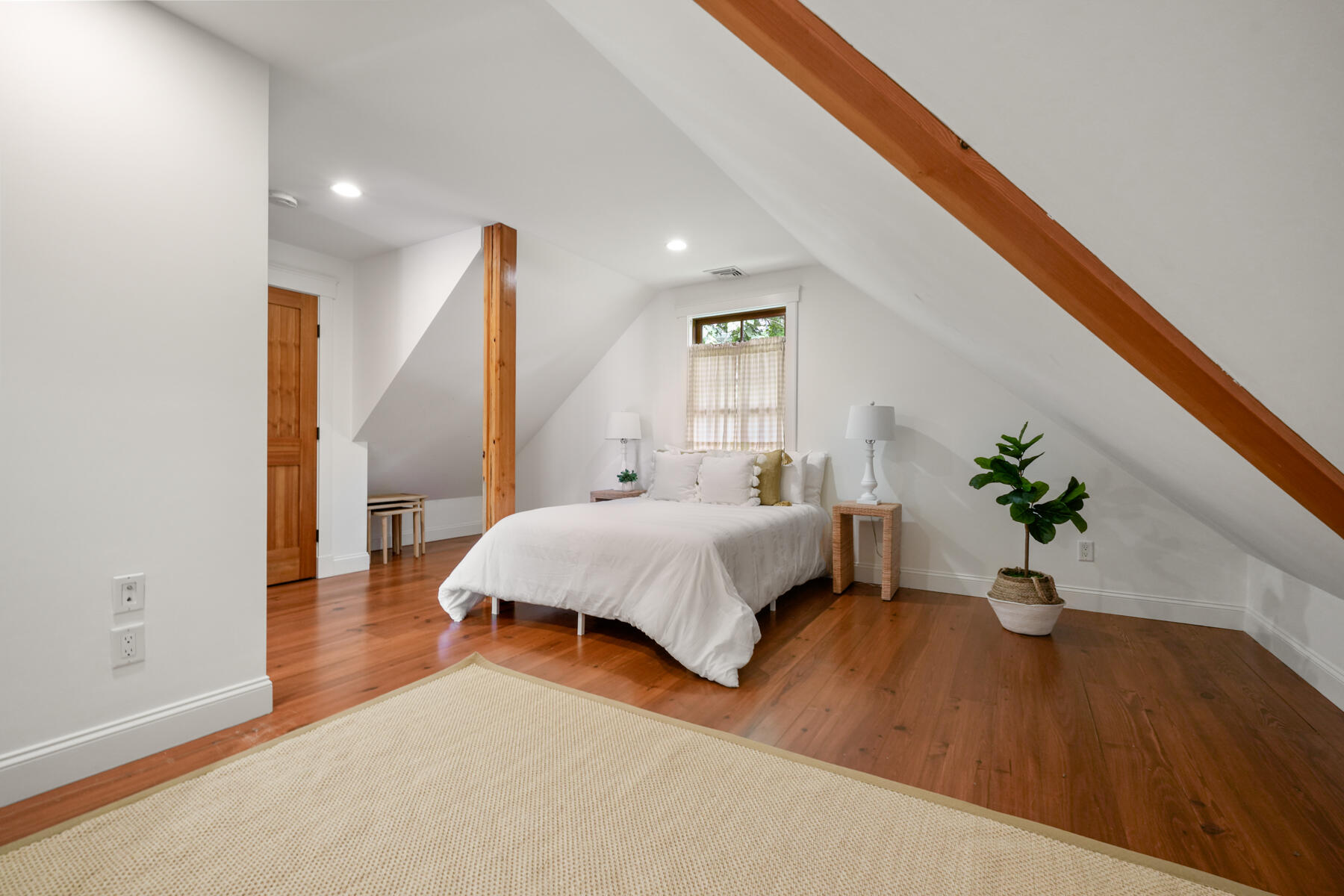 112 Wading Place Road Mashpee, MA 02649 - Photo 48 of 58 a bedroom with a bed and a potted plant