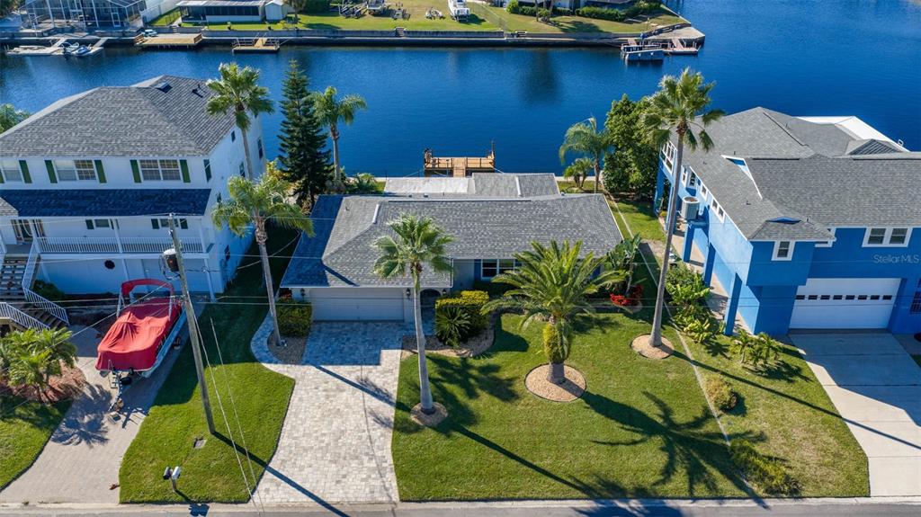 an aerial view of a house with a yard and lake view