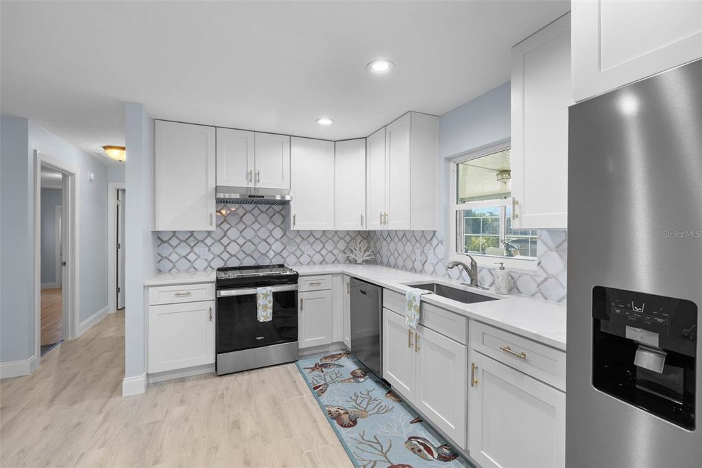 4151 Camelia Drive Hernando Beach, FL 34607 - Photo 12 of 37 a kitchen with a sink stove and refrigerator