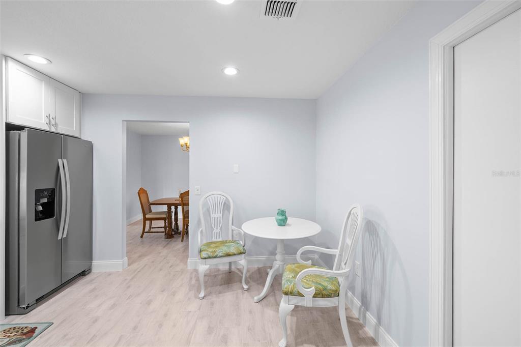4151 Camelia Drive Hernando Beach, FL 34607 - Photo 14 of 37 a dining room with furniture and a refrigerator