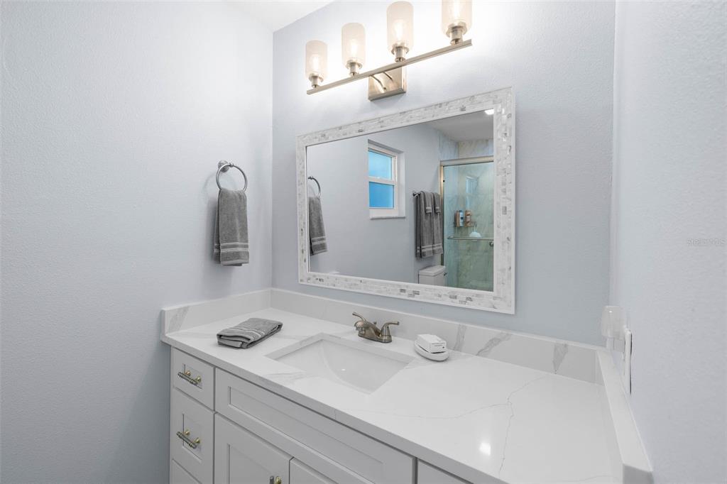 4151 Camelia Drive Hernando Beach, FL 34607 - Photo 17 of 37 a bathroom with a sink and a mirror