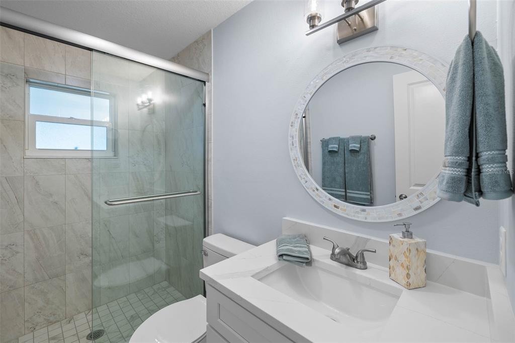 4151 Camelia Drive Hernando Beach, FL 34607 - Photo 21 of 37 a bathroom with a sink mirror toilet and shower
