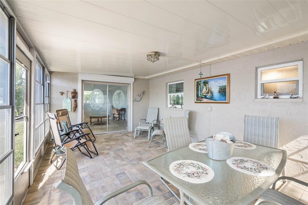 4151 Camelia Drive Hernando Beach, FL 34607 - Photo 24 of 37 a view of a dining room with furniture and wooden floor