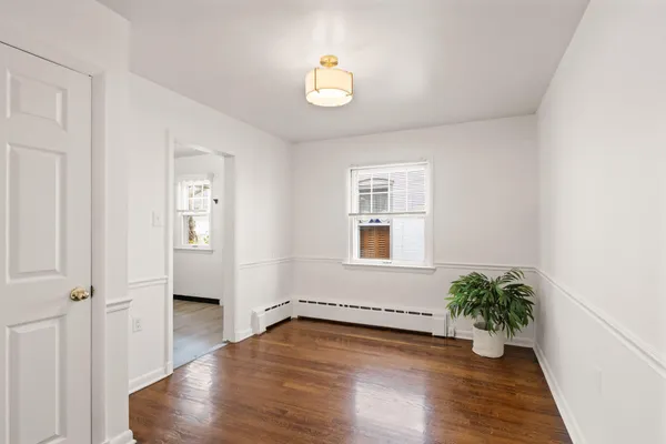 a view of an entryway with wooden floor and a potted plant