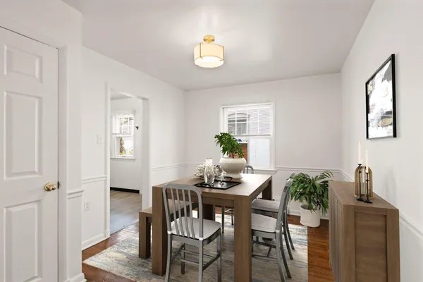 a dining room with furniture and window