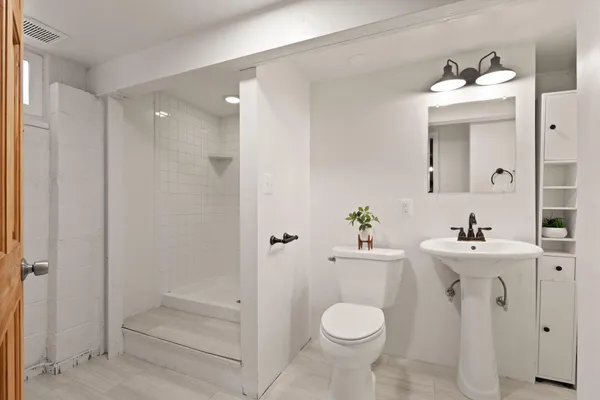 a bathroom with a sink toilet and shower