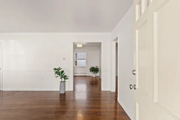 a view of an entryway with wooden floor
