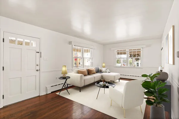 a living room with furniture potted plant and a window
