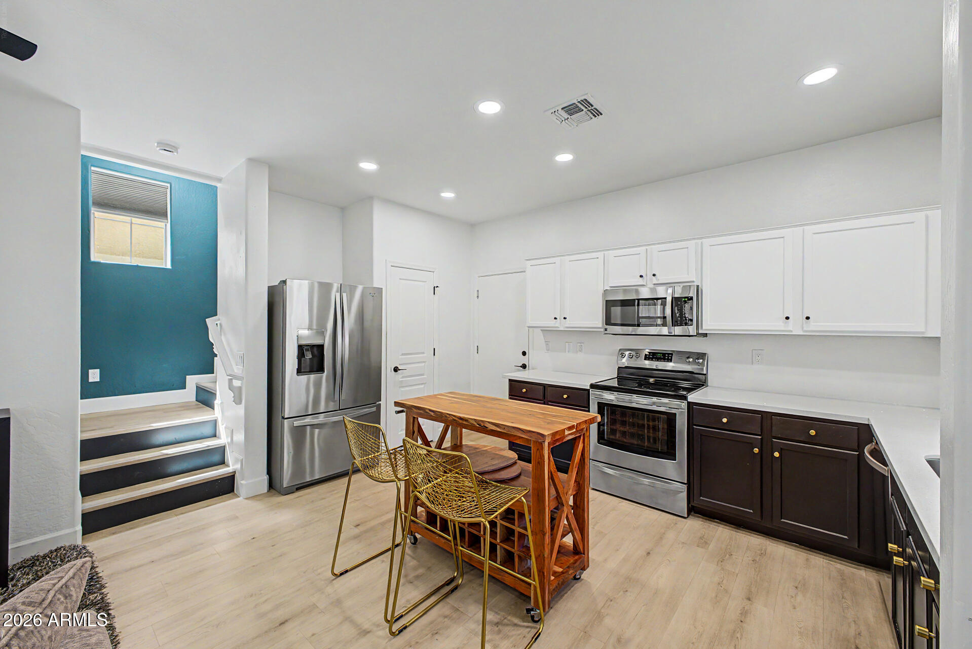 451 South Hawes Road, Unit 27 Mesa, AZ 85208 - Photo 8 of 27 a kitchen with stainless steel appliances a stove a sink and a refrigerator