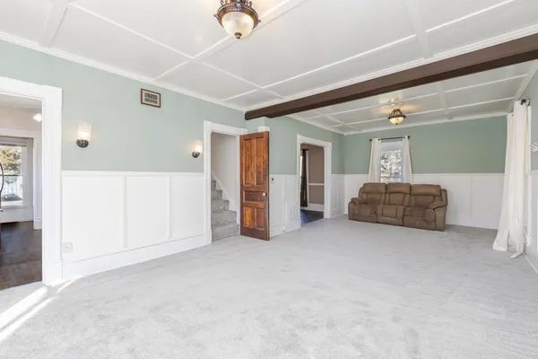 a view of empty room with wooden floor and window