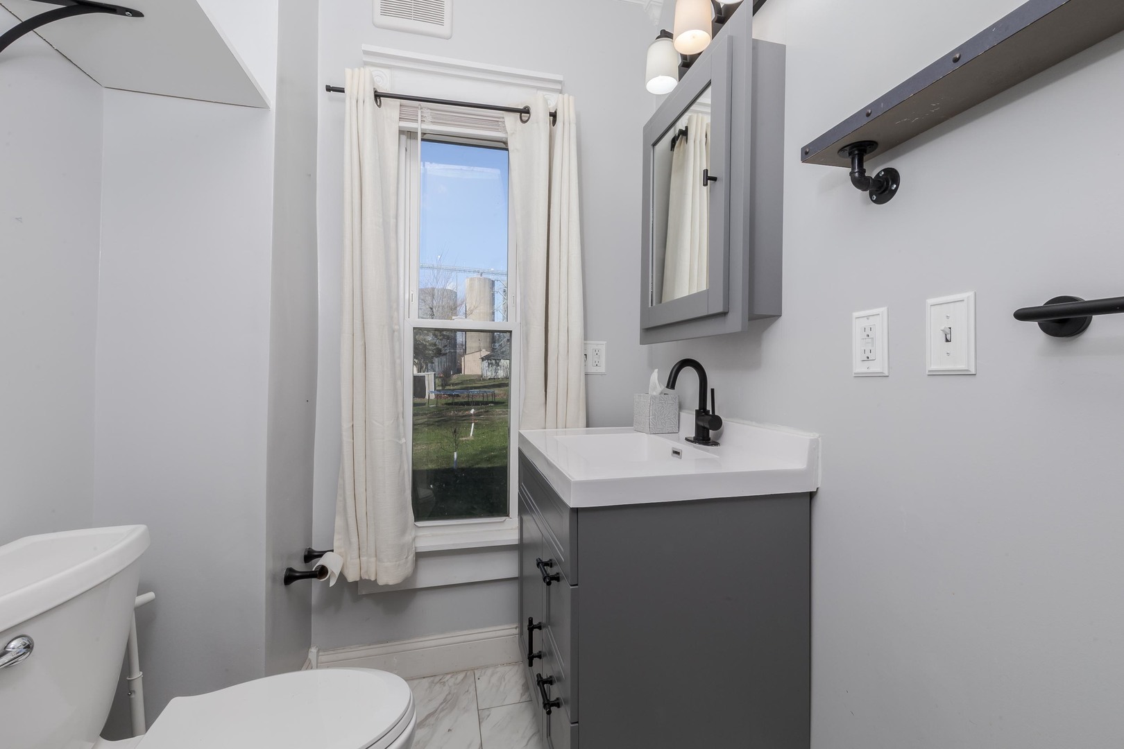 26 Lafayette Street Saunemin, IL 61769 - Photo 19 of 38 a bathroom with a toilet a sink and mirror
