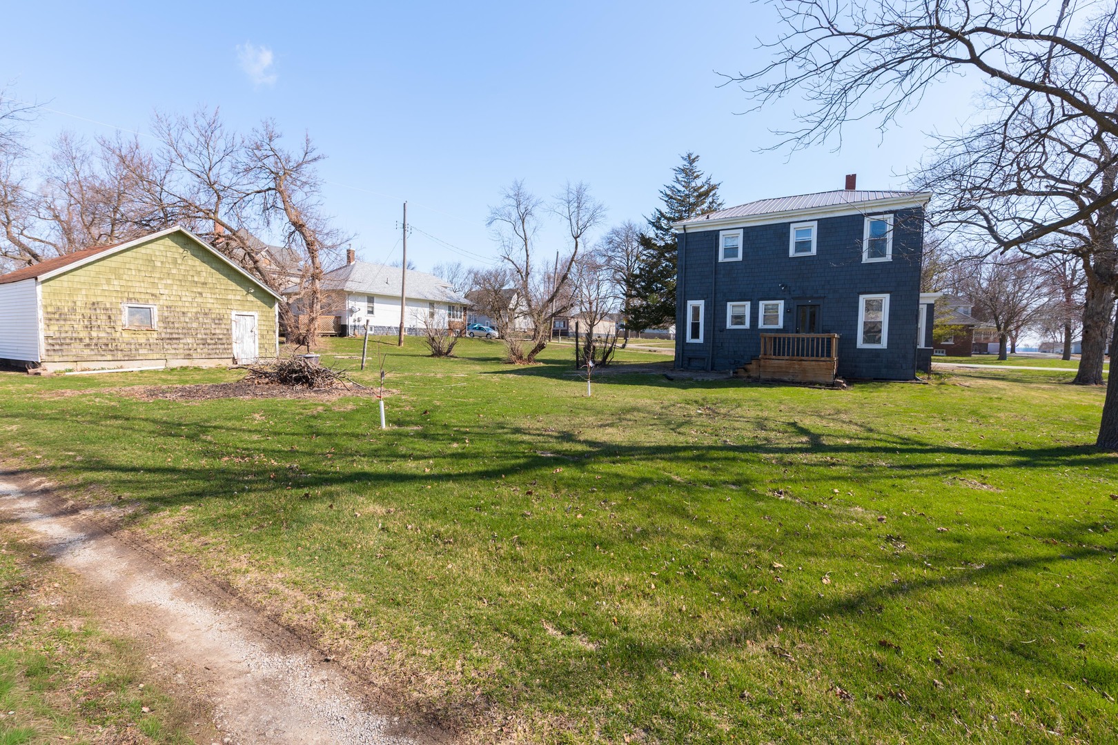 26 Lafayette Street Saunemin, IL 61769 - Photo 5 of 38 a view of a big house with a big yard and large trees