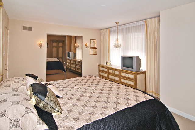 334 Downing Road Riverside, IL 60546 - Photo 9 of 23 a bedroom with a bed and a dresser in it