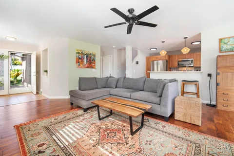 a living room with furniture and a wooden floor