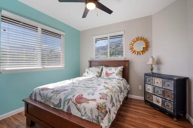 a bed room with a bed and a painting on the wall