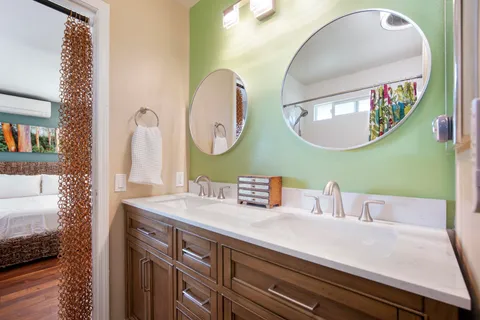 a en suite bathroom with a double vanity sink and a mirror