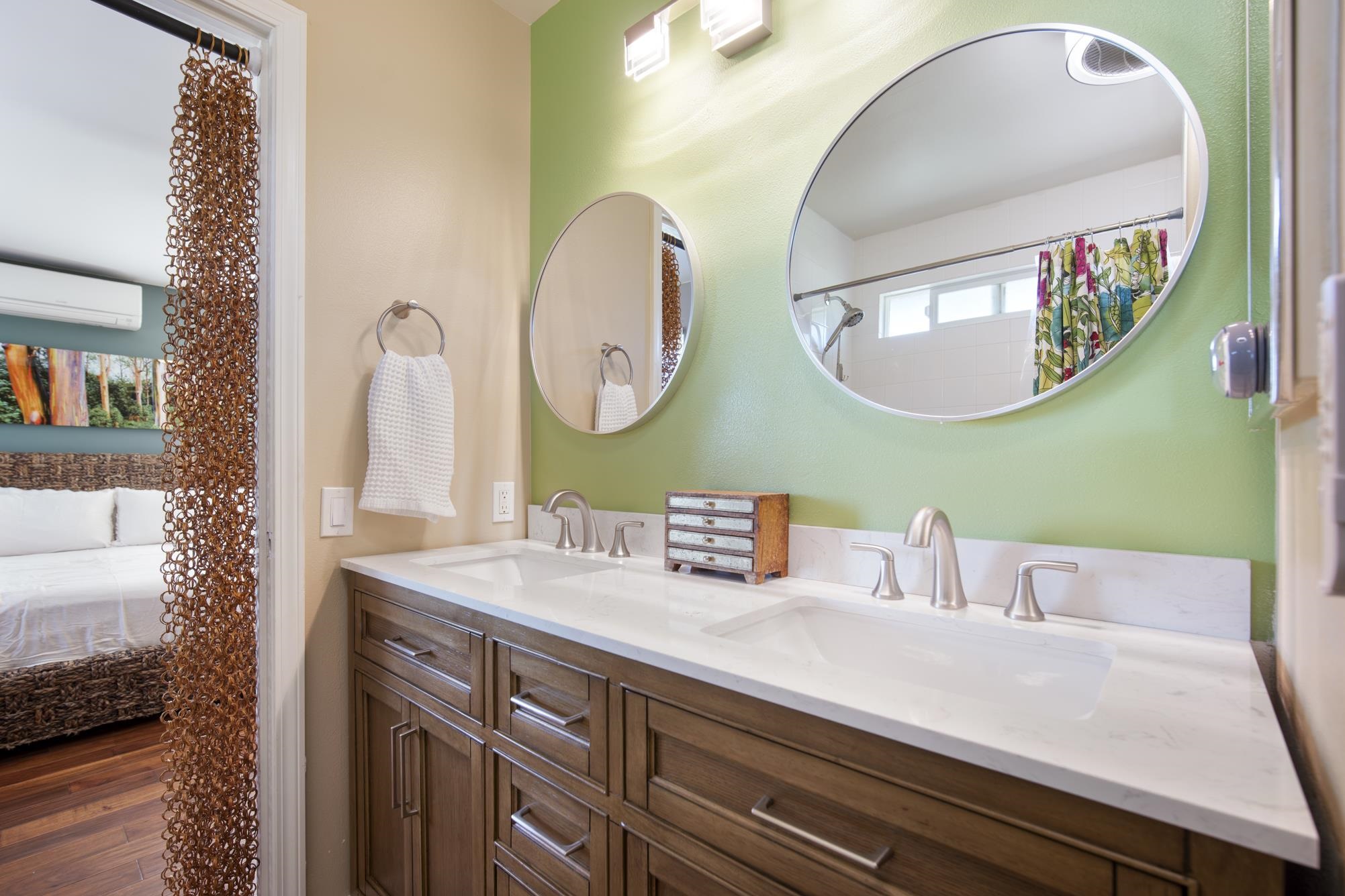223 Lau Oliwa Loop, Unit 38 Wailuku, HI 96793 - Photo 27 of 50 a bathroom with a sink and a mirror